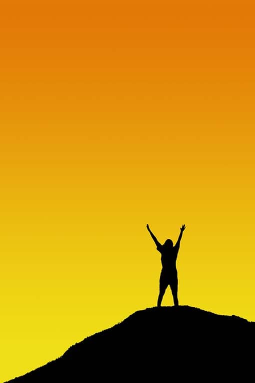 Person reaching up to the orange sky